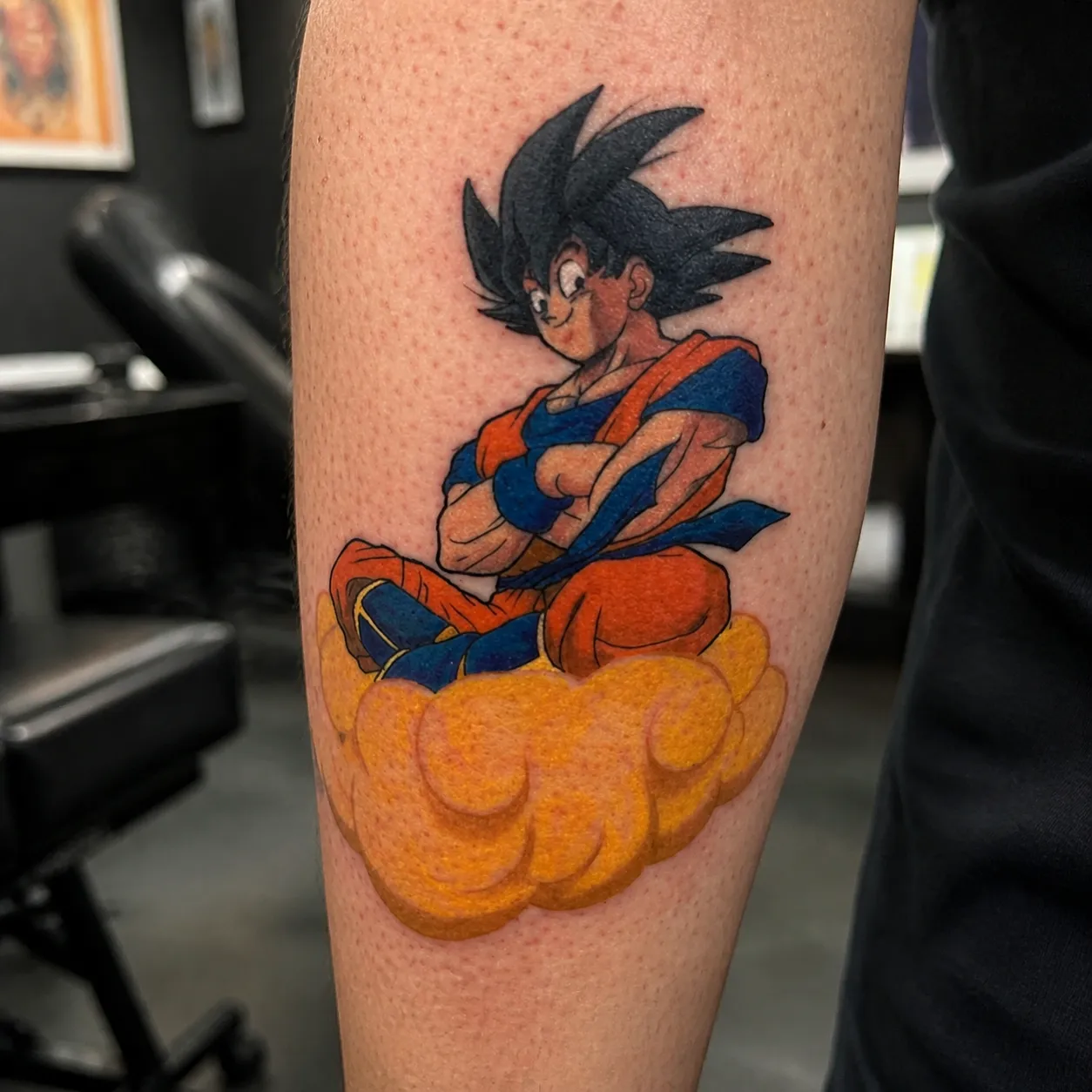 Full-color anime tattoo of Goku riding the Flying Nimbus